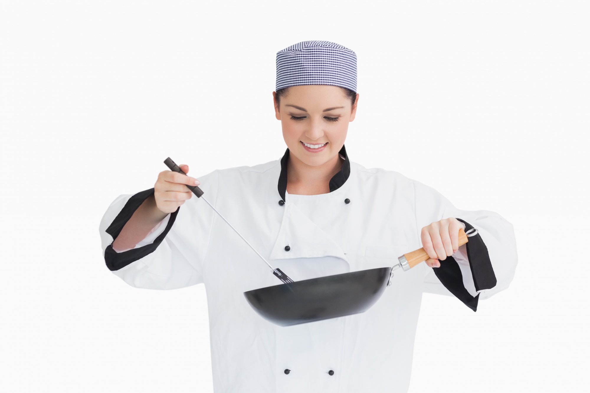 Instructor in a bright kitchen demonstrating a knife technique
